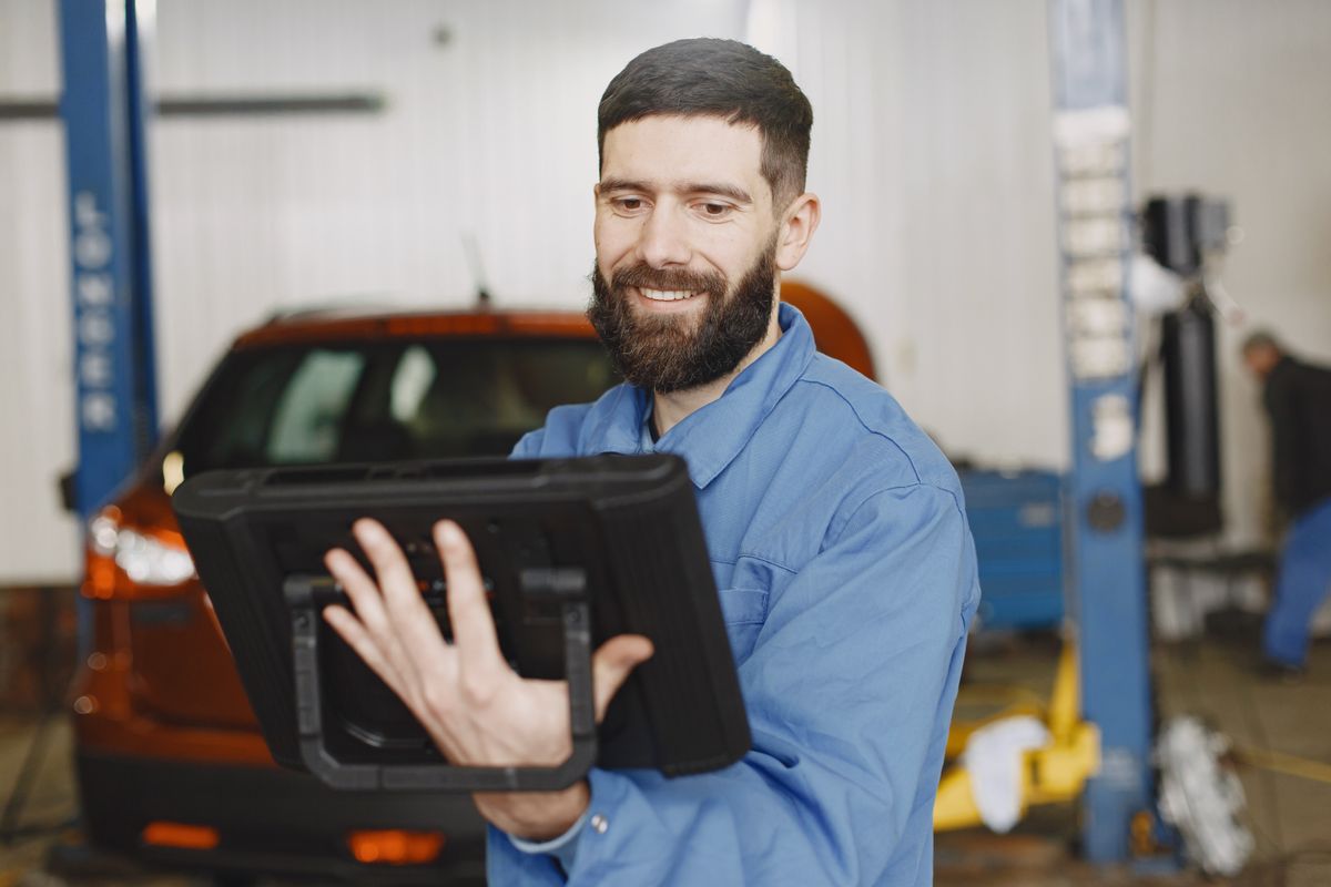 Transportation service professional reviewing diagnostics on a tablet